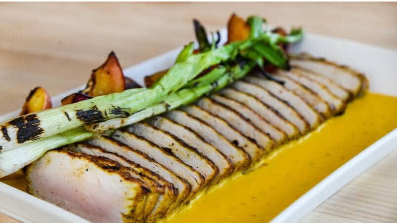 Grilled Curry Pork Loin With charred peaches and turmeric mustard sauce
